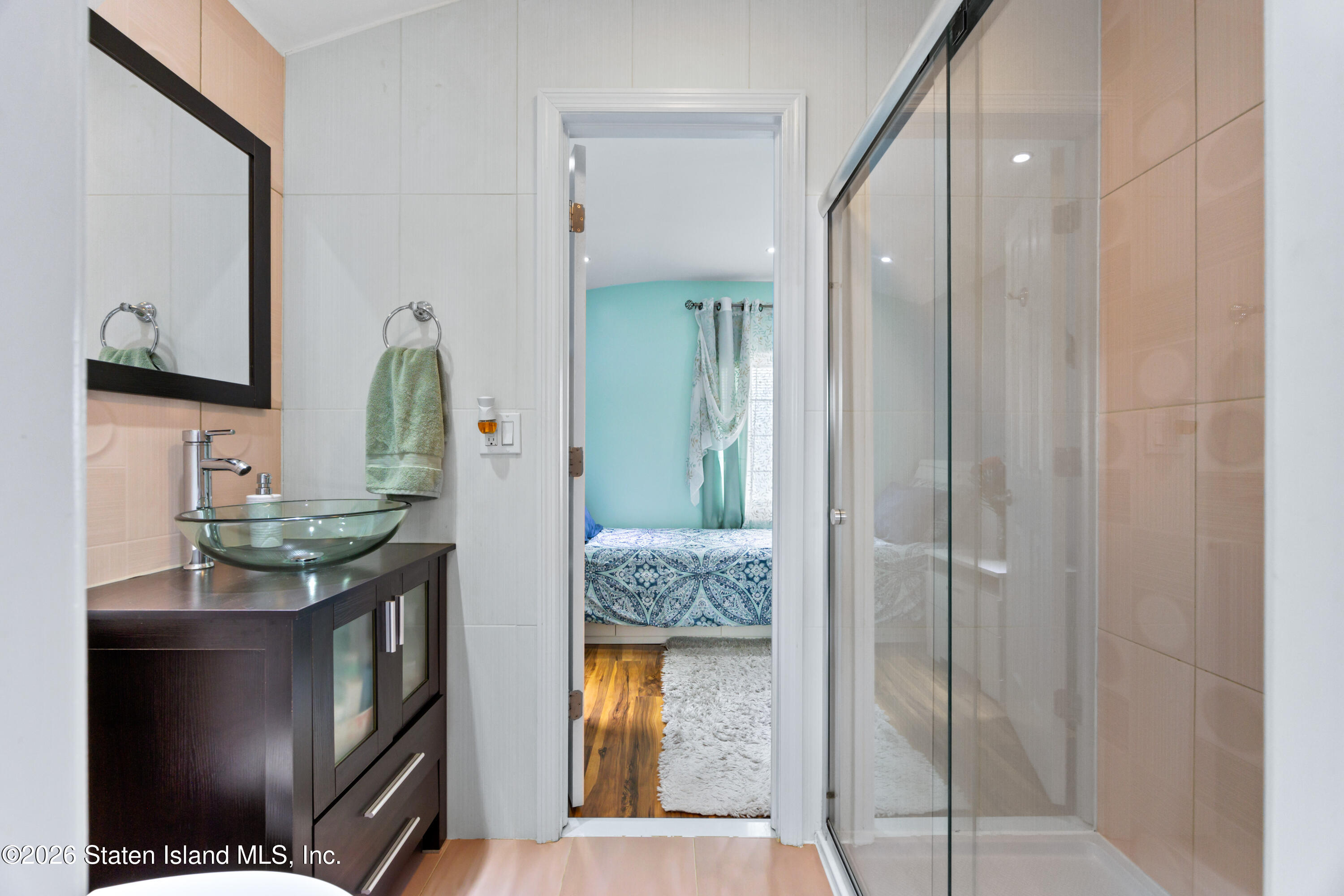 23 Stack Drive Staten Island, NY 10312 - Photo 19 of 29 a en suite bathroom with a granite countertop sink and a mirror