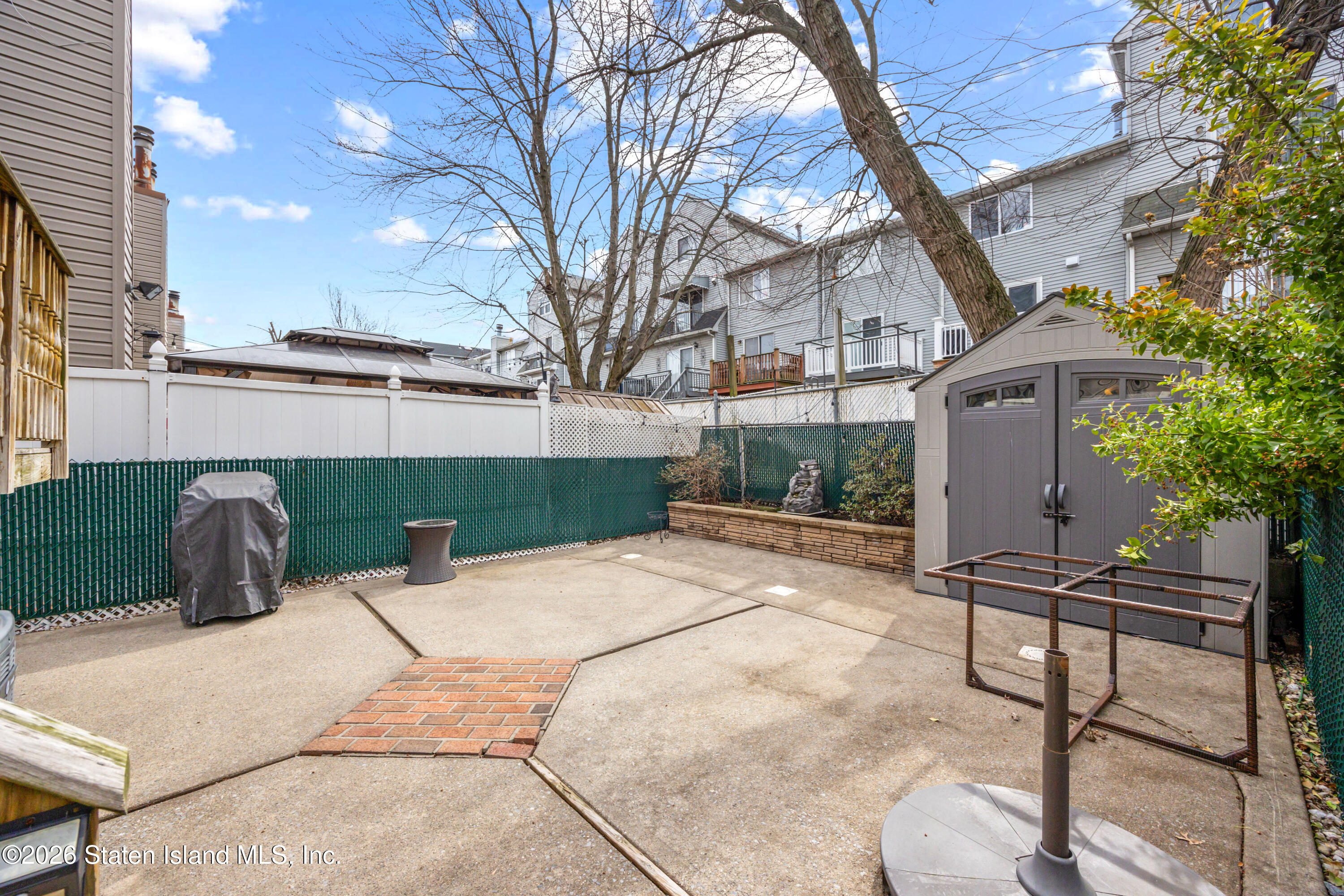23 Stack Drive Staten Island, NY 10312 - Photo 26 of 29 a backyard of a house with table and chairs