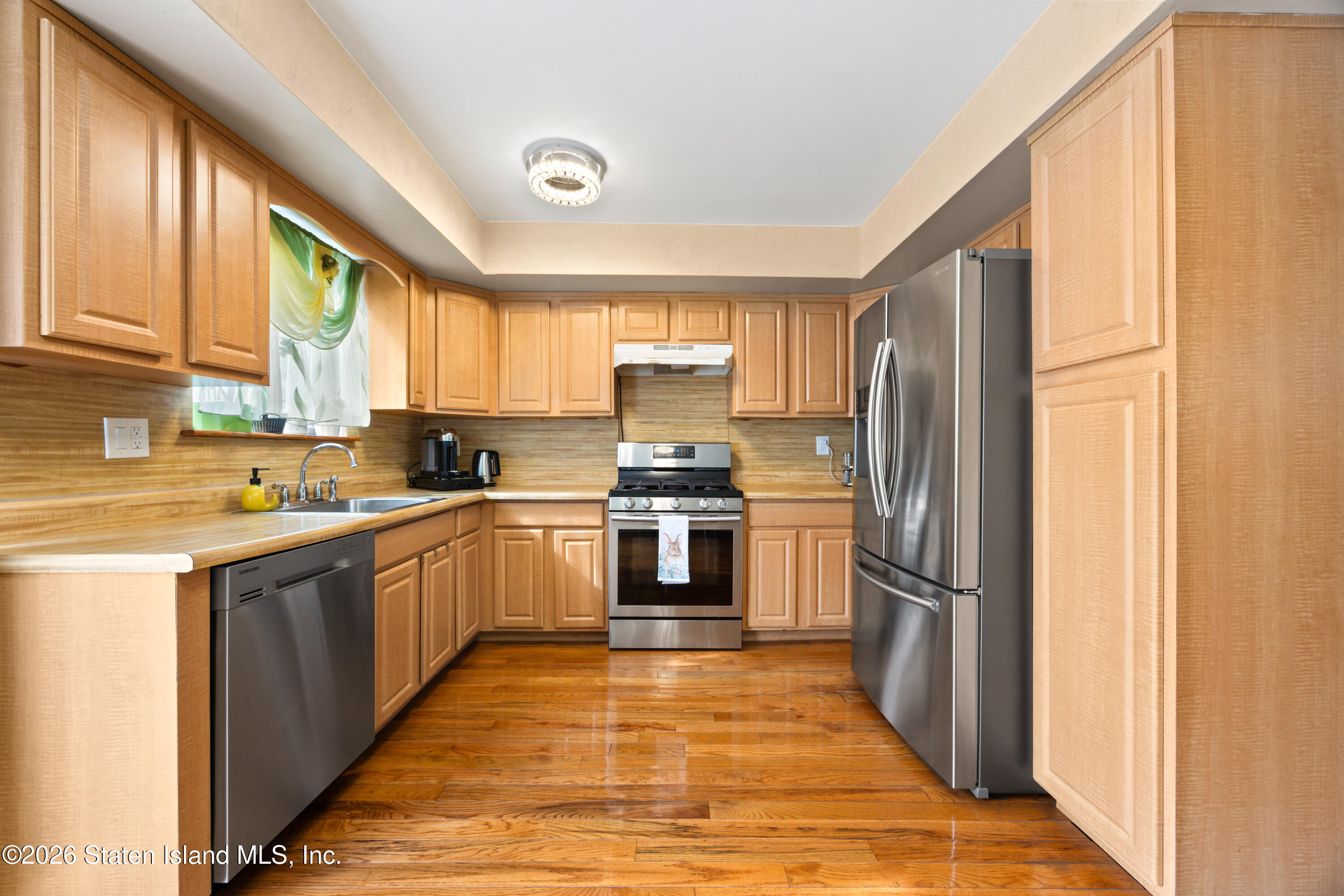 23 Stack Drive Staten Island, NY 10312 - Photo 8 of 29 a kitchen with stainless steel appliances granite countertop a refrigerator a sink dishwasher a stove and white countertops with wooden floor