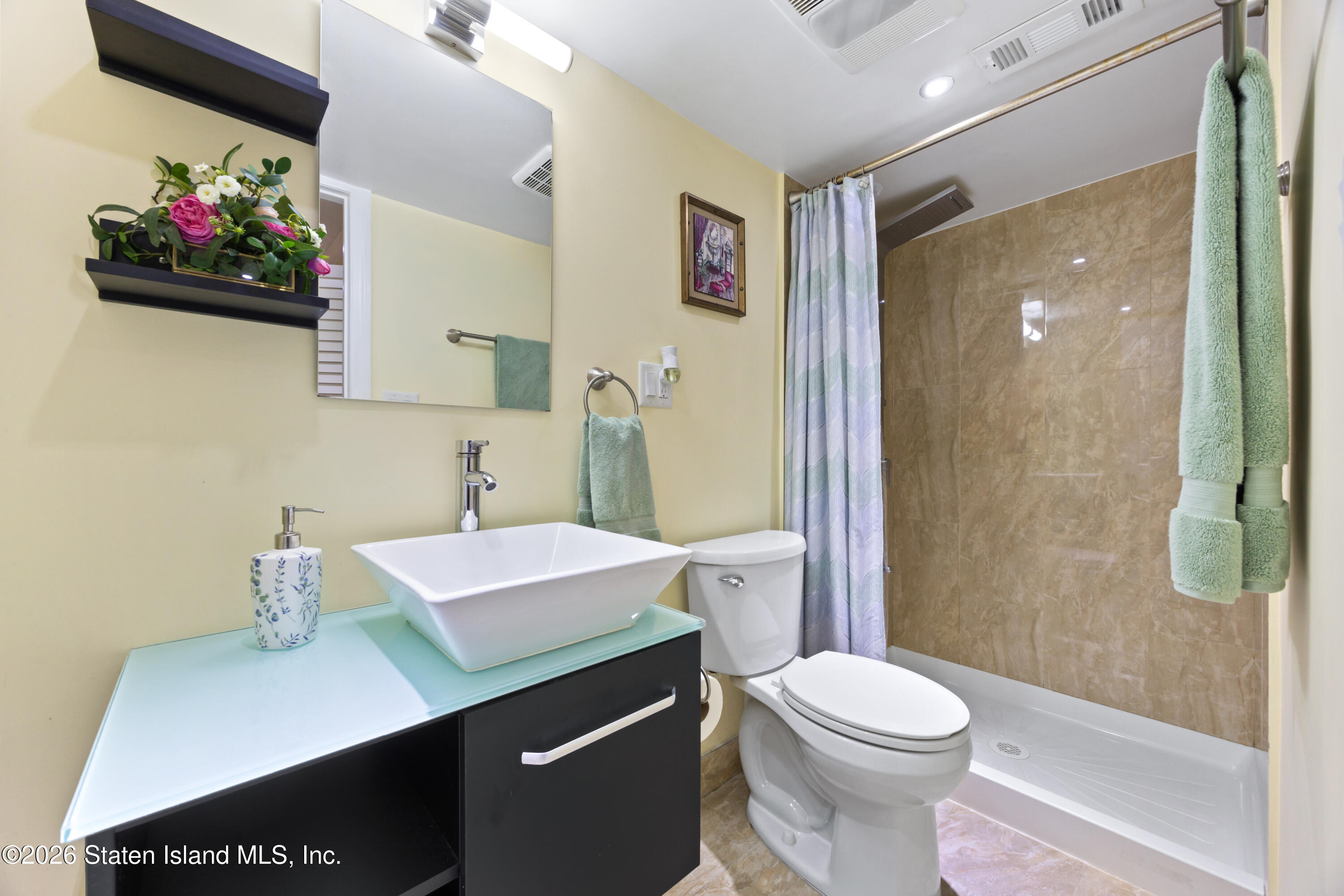 23 Stack Drive Staten Island, NY 10312 - Photo 9 of 29 a bathroom with a sink a toilet and shower