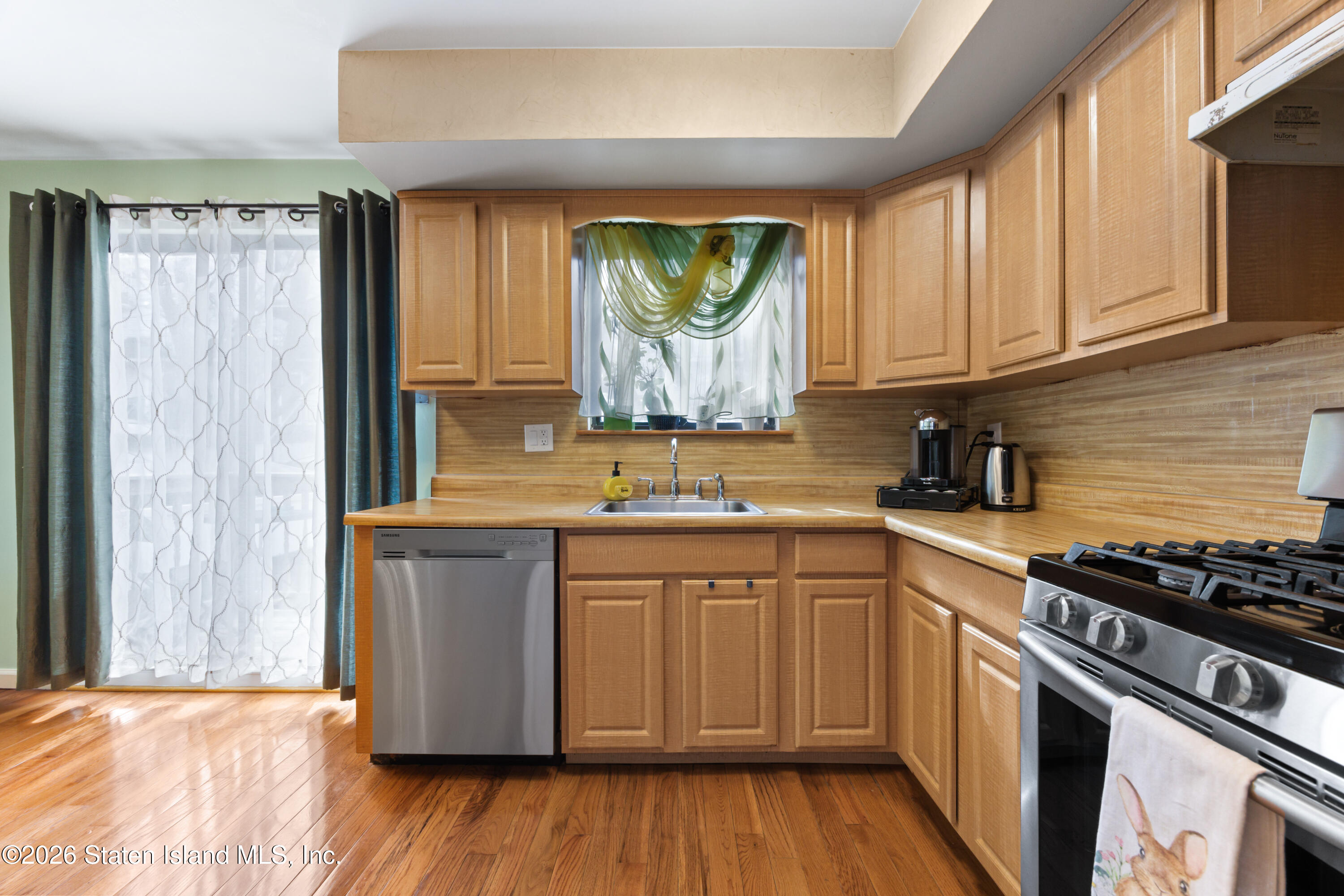 23 Stack Drive Staten Island, NY 10312 - Photo 10 of 29 a kitchen with stainless steel appliances granite countertop a stove a sink dishwasher and wooden cabinets with wooden floor