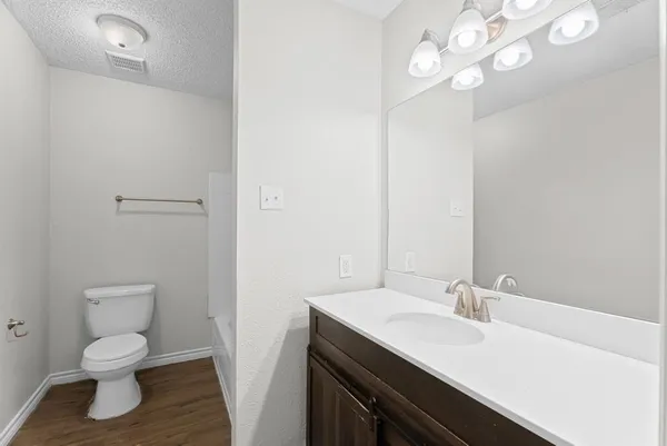 a white toilet sitting next to a bath tub