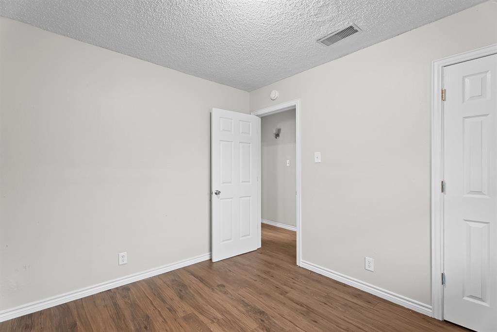 429 Johnson Street, Unit 10 Longview, TX 75602 - Photo 10 of 12 a view of an empty room with wooden floor