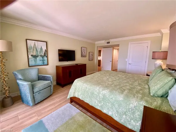 a bedroom with a bed window and couch