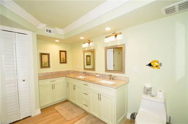 a spacious bathroom with a granite countertop sink and a mirror