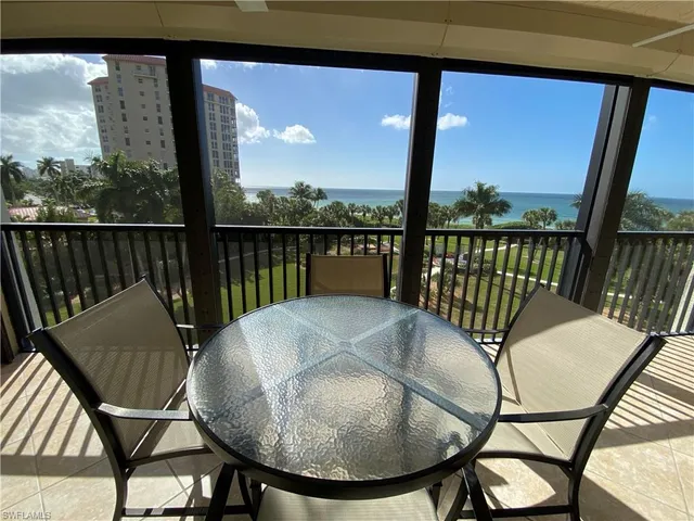 a view of a chairs and table in the balcony