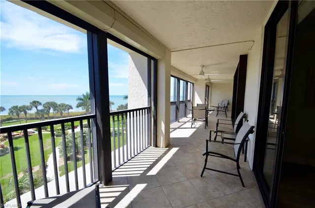 a view of a porch with chairs and backyard