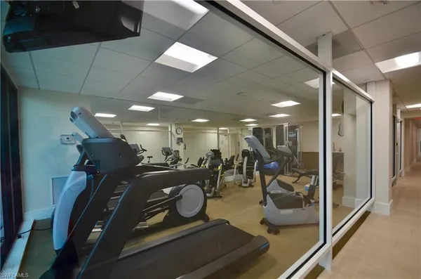 a bedroom with furniture and a large window