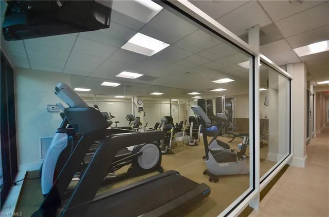 a bedroom with furniture and a large window