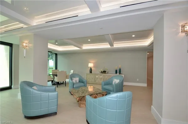 a living room with furniture and large windows