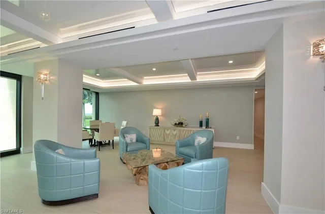 a living room with furniture and large windows