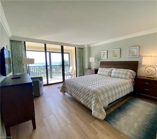 a bedroom with a large bed and a large window