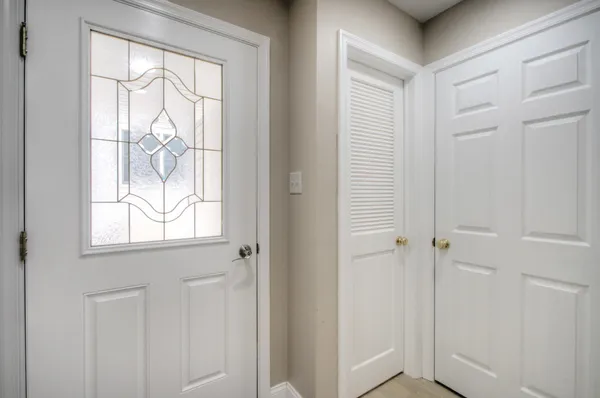 a large bed sitting in a bedroom next to a window