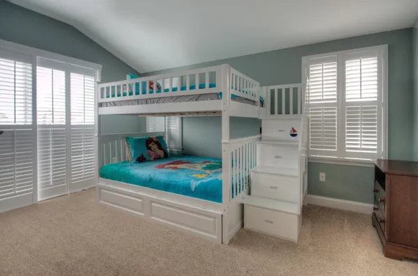 a bedroom with furniture and a baby crib