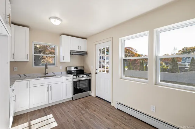 a kitchen with stainless steel appliances granite countertop a stove a sink and a refrigerator