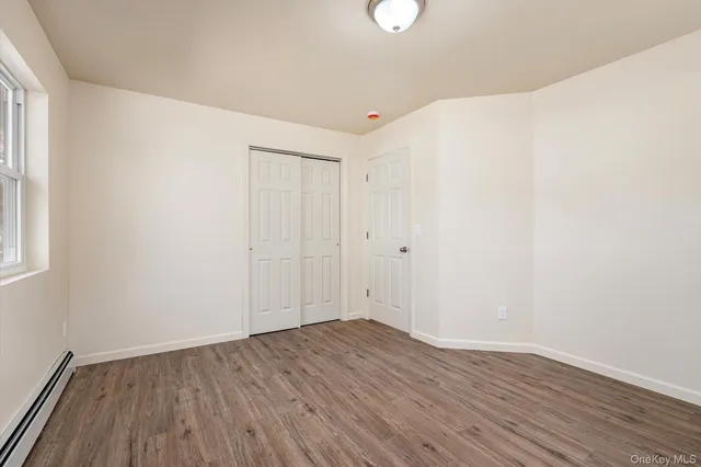 an empty room with wooden floor