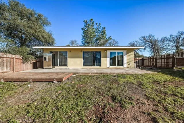 a view of a house with a backyard