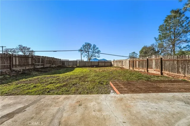 a view of a white house with a yard