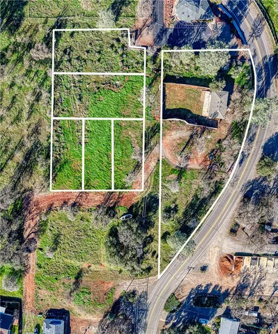 a view of a yard with a large tree