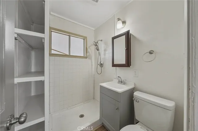 a bathroom with a toilet sink and shower