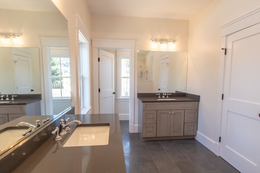 62 Maple Street, Unit 2 Needham, MA 02492 - Photo 13 of 25 a spacious bathroom with a granite countertop sink and a mirror