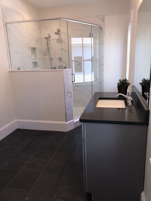 62 Maple Street, Unit 2 Needham, MA 02492 - Photo 14 of 25 a bathroom with a sink and a mirror