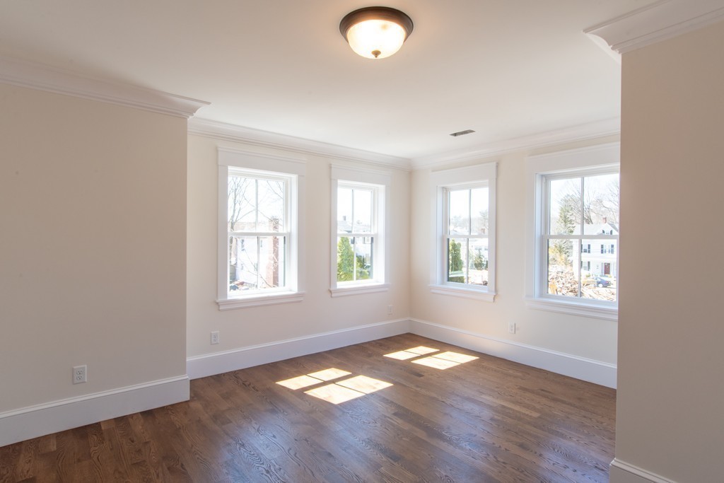 62 Maple Street, Unit 2 Needham, MA 02492 - Photo 20 of 25 a view of empty room with wooden floor and fan