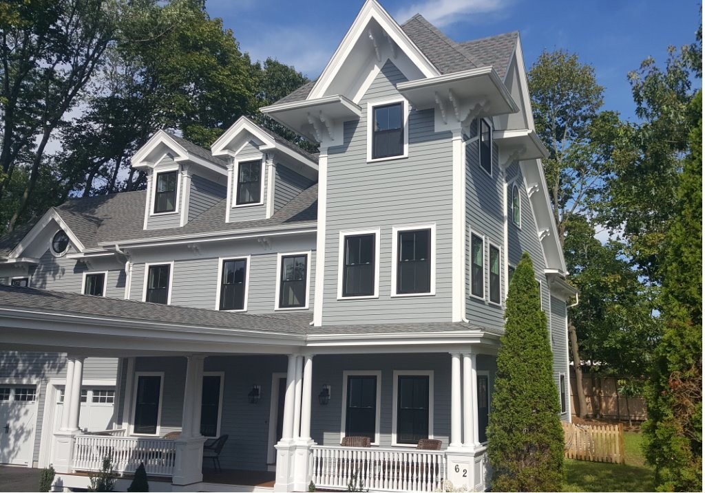 62 Maple Street, Unit 2 Needham, MA 02492 - Photo 2 of 25 a view of a white house with large windows and a small yard