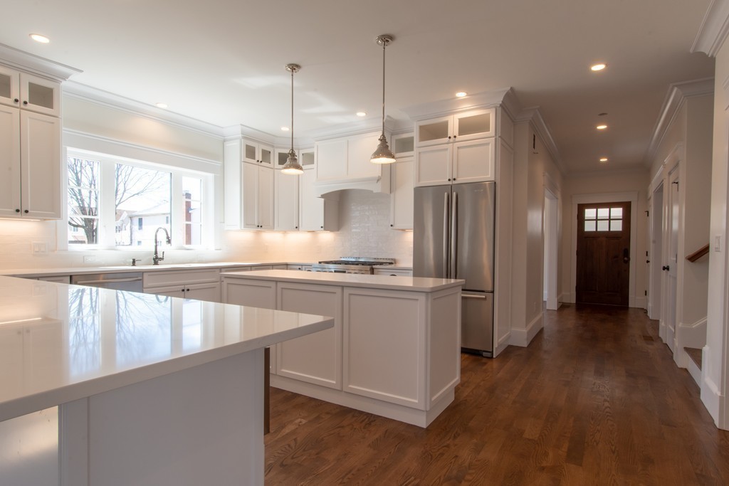 62 Maple Street, Unit 2 Needham, MA 02492 - Photo 8 of 25 a large kitchen with granite countertop a large counter top a sink stainless steel appliances and cabinets