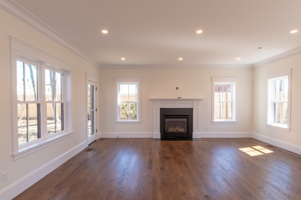 62 Maple Street, Unit 2 Needham, MA 02492 - Photo 10 of 25 a view of an empty room with wooden floor and a window