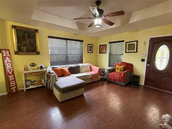 a bedroom with furniture and wooden floor