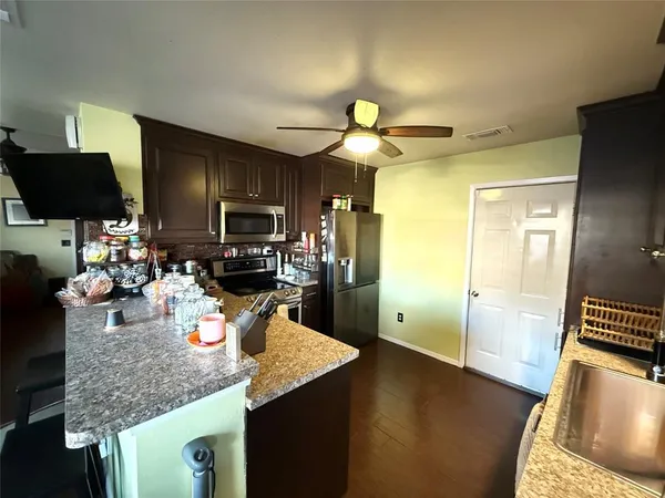 a kitchen with a sink a stove and cabinets