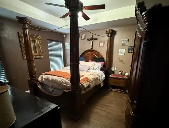 a bedroom with a bed and a chandelier
