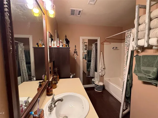 a bathroom with sink a toilet a mirror and shower