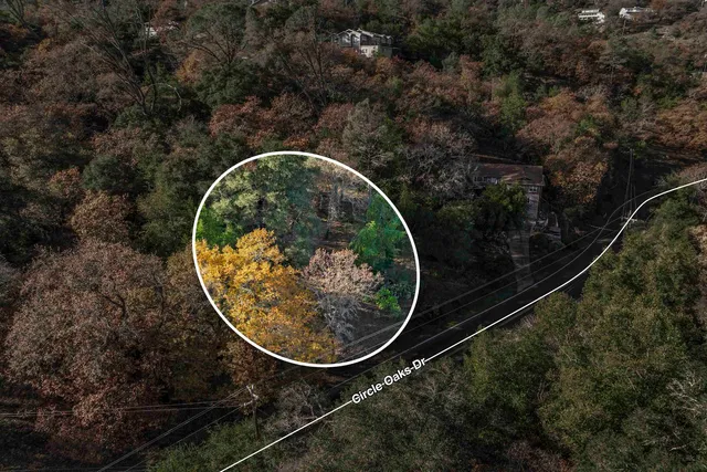 an aerial view of a house with lots of trees
