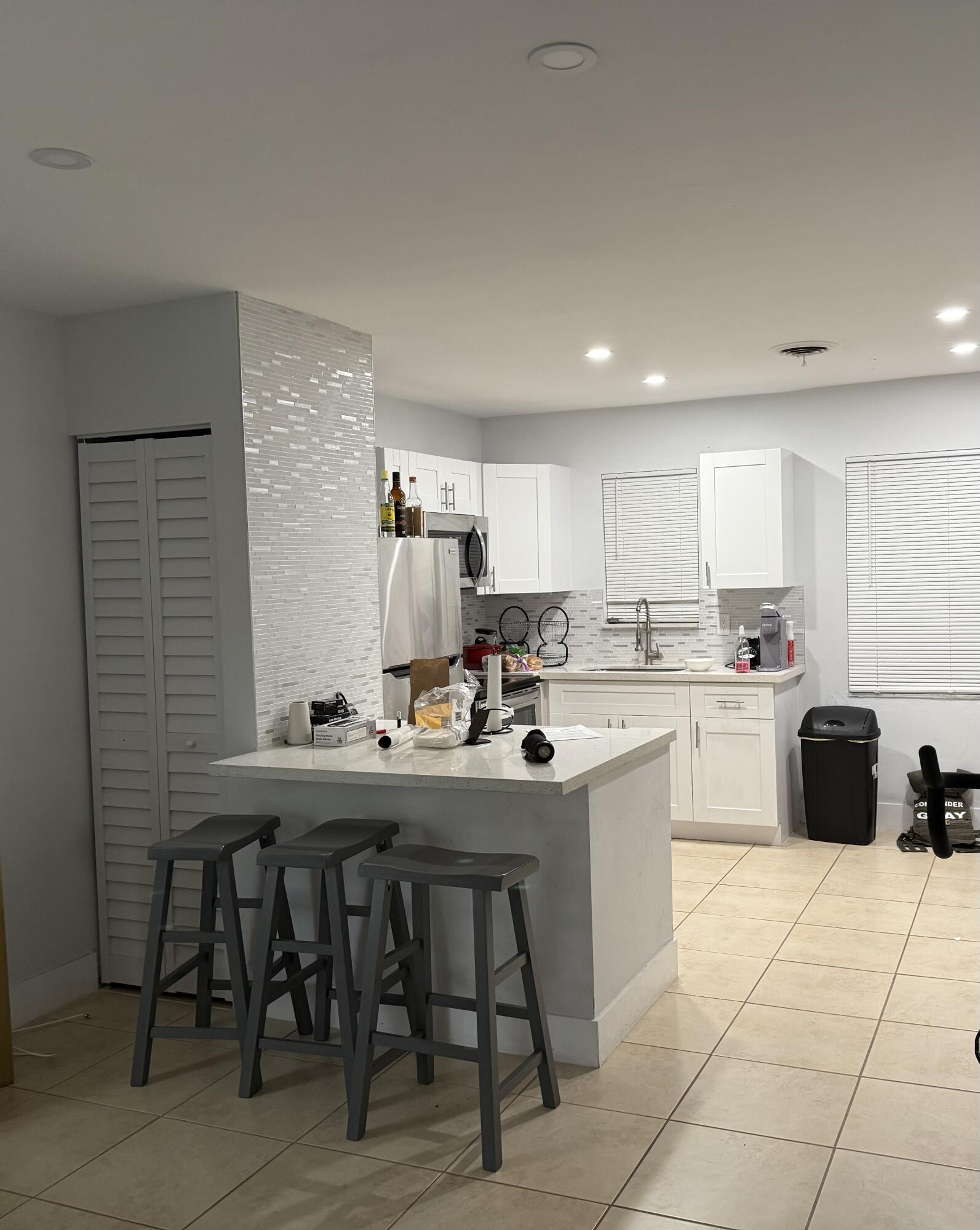 a kitchen with a sink a counter top space and stainless steel appliances
