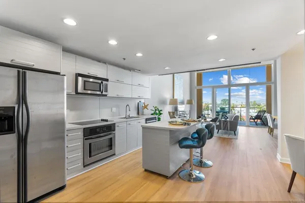 a kitchen with stainless steel appliances granite countertop a sink stove and microwave