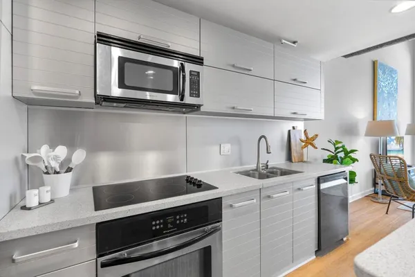 a kitchen with stainless steel appliances a sink stove and cabinets