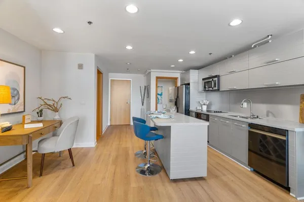 a living room with furniture and painting on the wall