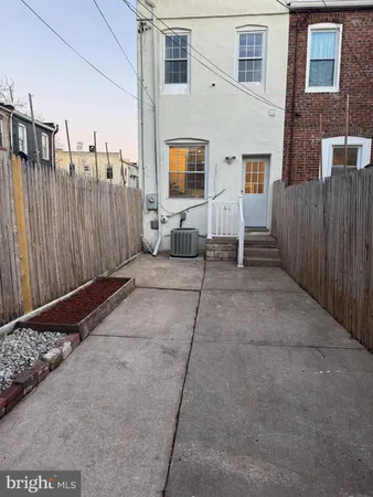 a view of a house with wooden fence