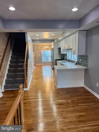 a view of kitchen with cabinets and wooden floor