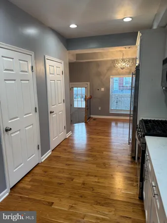 a view of a hallway with wooden floor