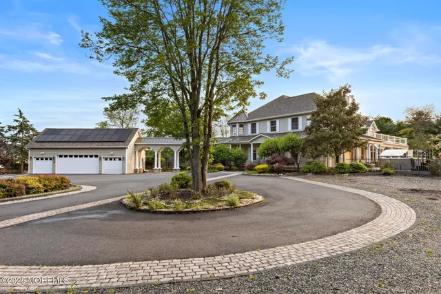 a dining room with furniture large windows and wooden floor