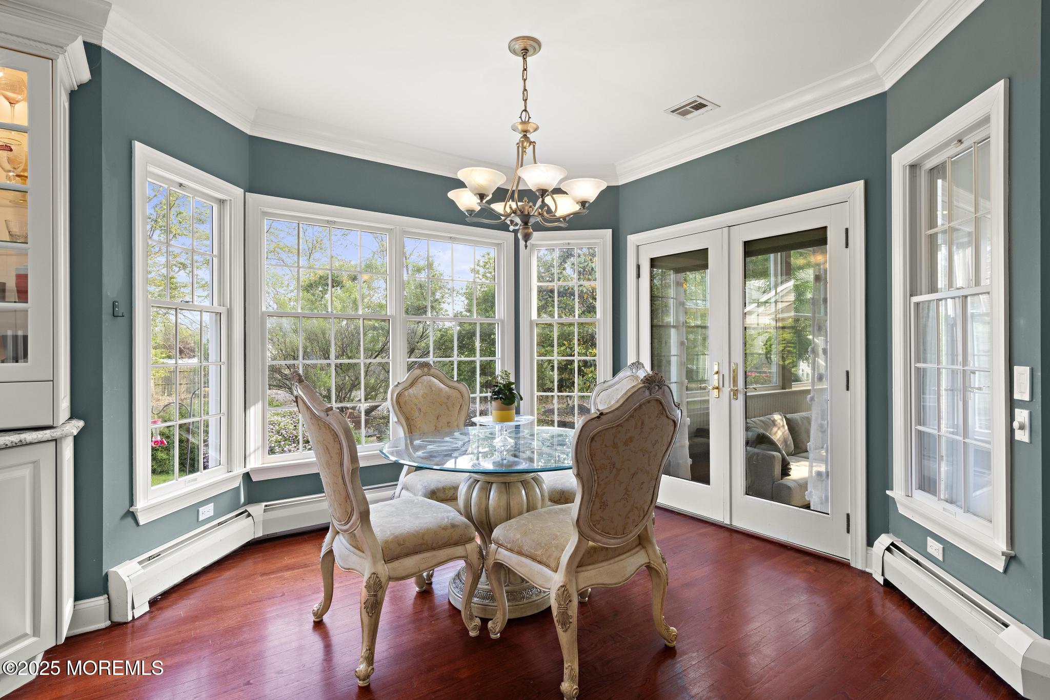 1413 Gully Road Wall, NJ 07719 - Photo 24 of 82 a dining room with furniture large windows and wooden floor