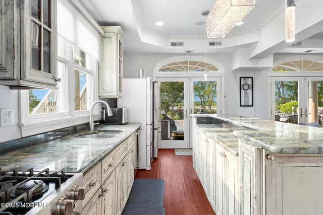 a bathroom with a granite countertop sink mirror and bathtub