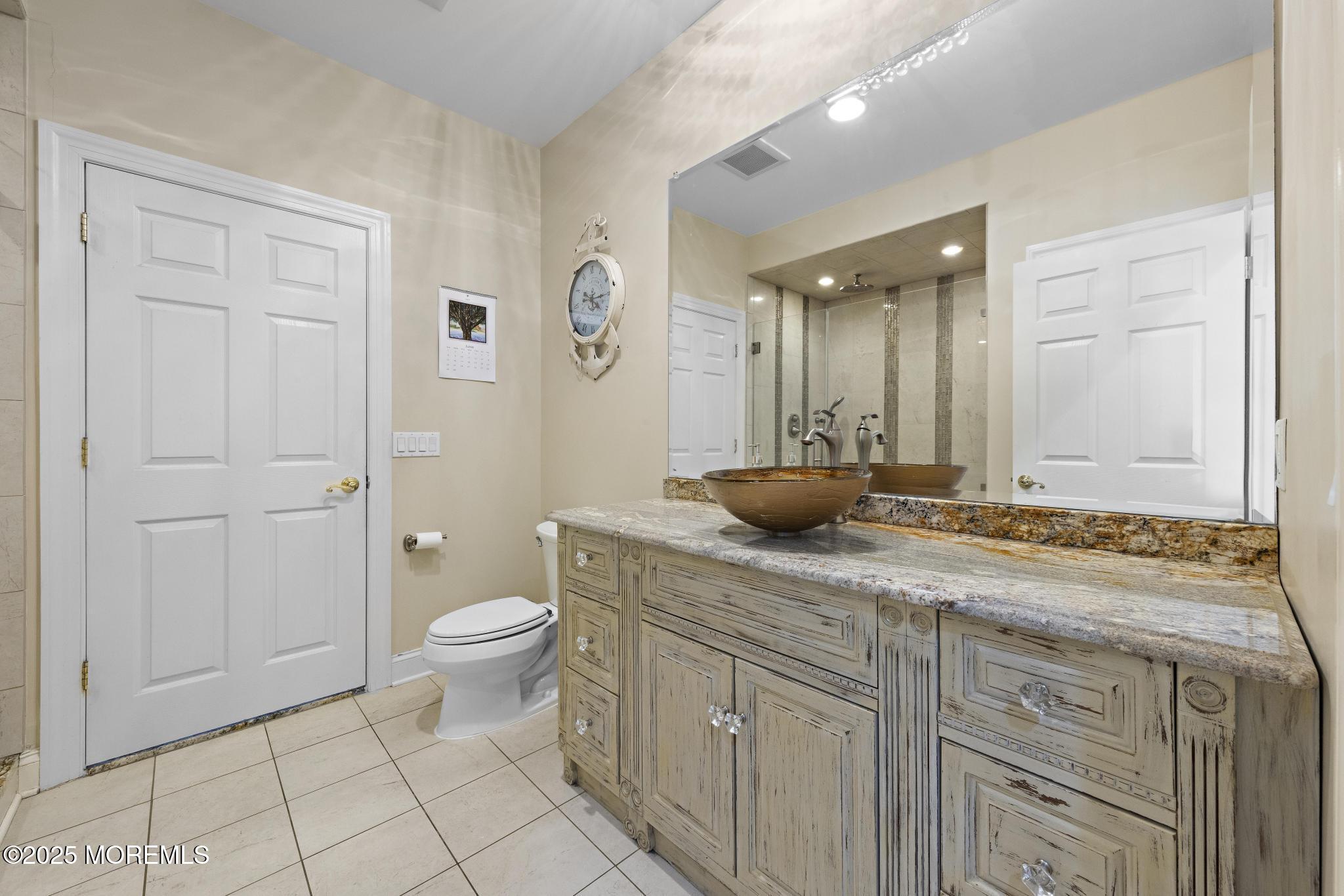 1413 Gully Road Wall, NJ 07719 - Photo 37 of 82 a bathroom with a granite countertop sink a toilet and a shower