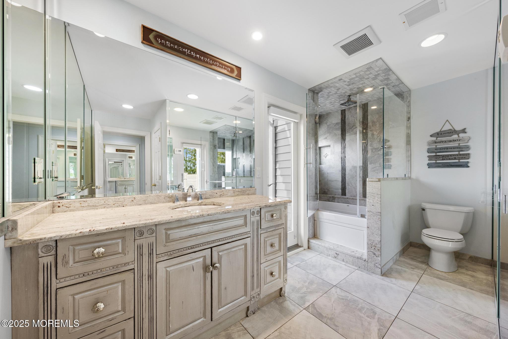 1413 Gully Road Wall, NJ 07719 - Photo 43 of 82 a spacious bathroom with a granite countertop sink a toilet a mirror and shower