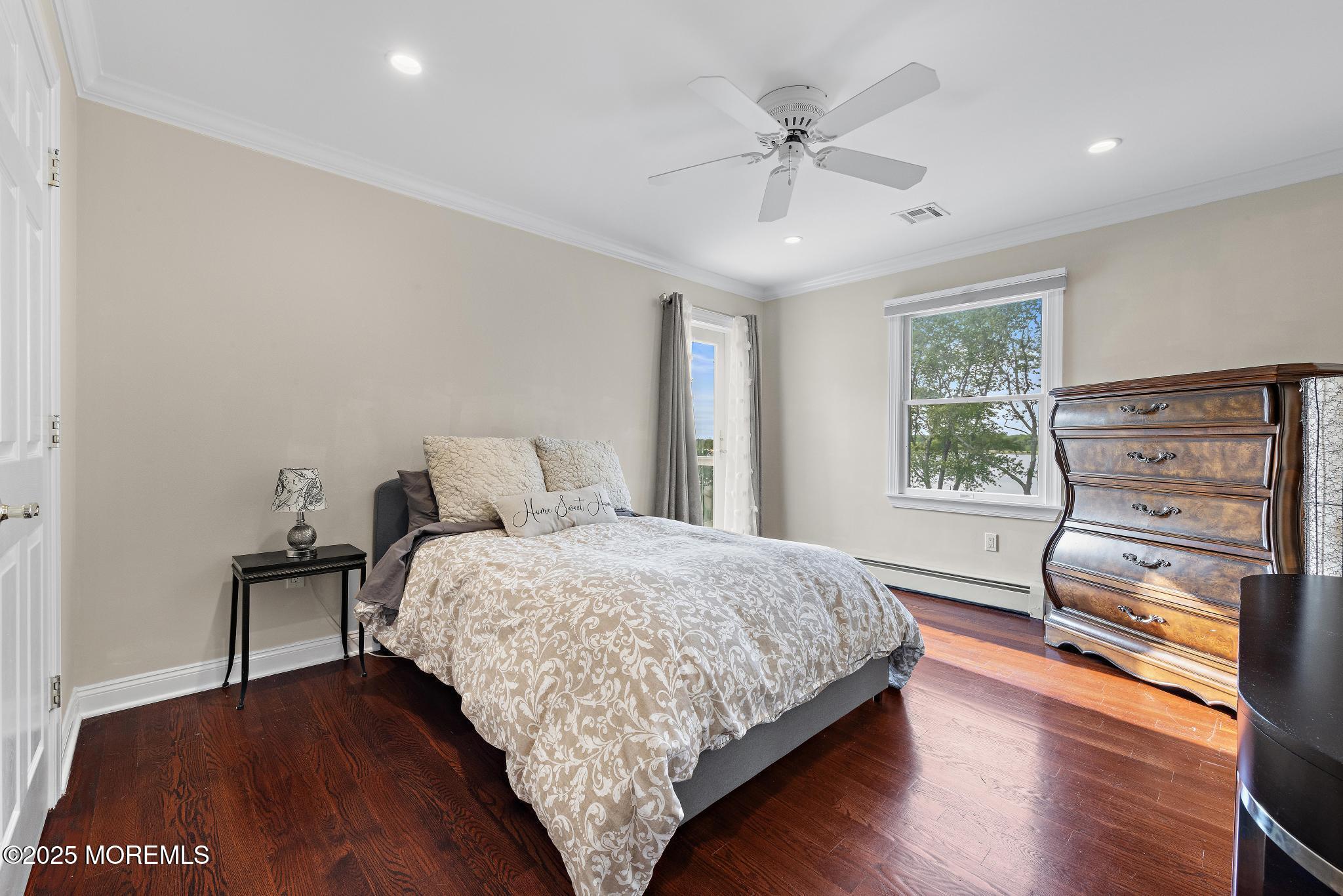 1413 Gully Road Wall, NJ 07719 - Photo 51 of 82 a bedroom with a bed and a dresser with wooden floor