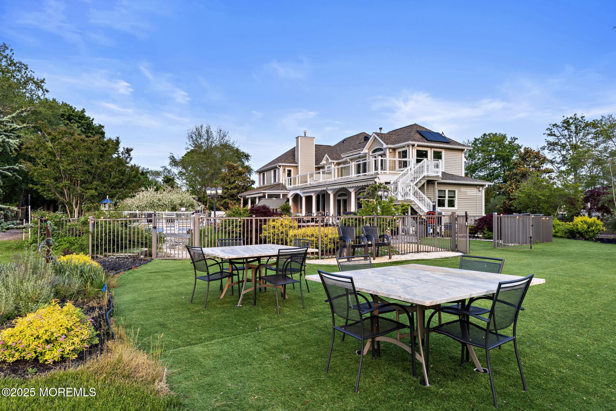 1413 Gully Road Wall, NJ 07719 - Photo 64 of 82 a view of a house with backyard sitting area and garden