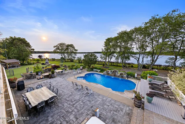 a view of a house with a swimming pool and sitting area